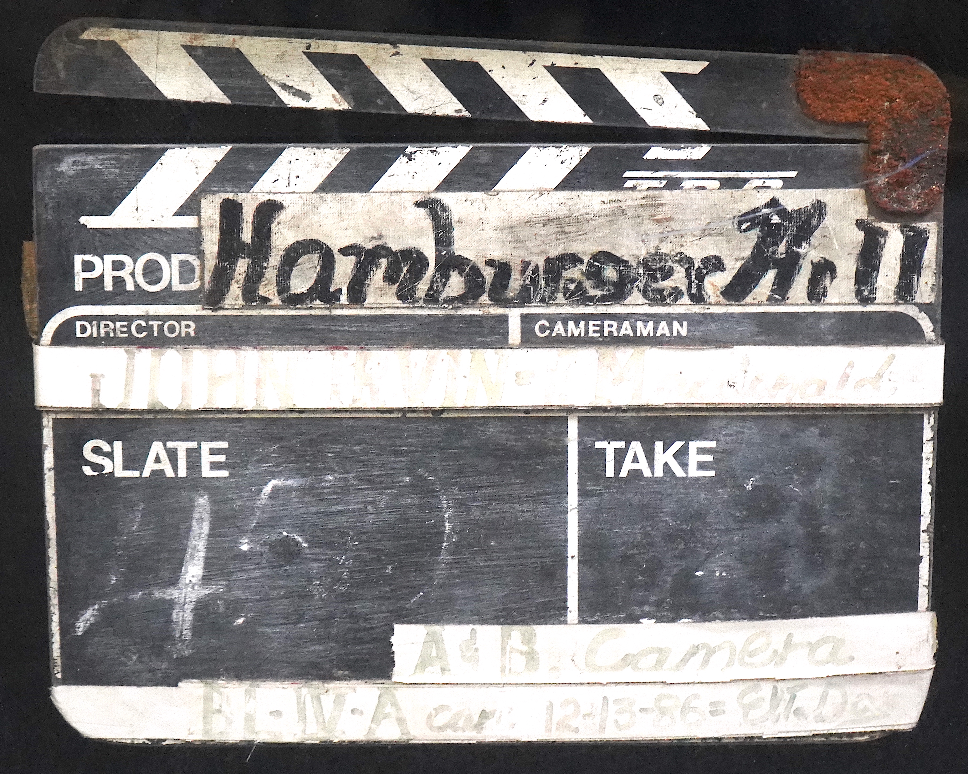 A clapperboard for A & B Camera for the film Hamburger Hill, framed and glazed.